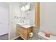Well-lit bathroom with a wooden vanity, modern sink, updated lighting, and a toilet at 2259 Costa Rican Dr # 23, Clearwater, FL 33763