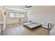 Spacious bedroom with lots of natural light featuring a ceiling fan and laminated wood flooring at 2259 Costa Rican Dr # 23, Clearwater, FL 33763
