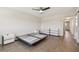 Bedroom with ceiling fan and laminated wood flooring with white dressers and view to hallway at 2259 Costa Rican Dr # 23, Clearwater, FL 33763