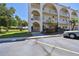 Three story exterior featuring archways, lush landscaping, and convenient parking at 2259 Costa Rican Dr # 23, Clearwater, FL 33763