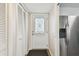 Hallway featuring wooden floors, white trim, hall closet, and a stainless steel refrigerator at 2259 Costa Rican Dr # 23, Clearwater, FL 33763