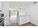Bright kitchen with updated cabinets, flooring, and a pass-through to the living area at 2259 Costa Rican Dr # 23, Clearwater, FL 33763