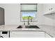Kitchen featuring white cabinets, modern countertops, and a stainless steel kitchen sink at 2259 Costa Rican Dr # 23, Clearwater, FL 33763
