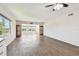Bright living area with wood flooring, ceiling fan, and a view of the pool at 2259 Costa Rican Dr # 23, Clearwater, FL 33763