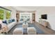 Inviting living room furnished with stylish wicker furniture and a bright blue rug at 2259 Costa Rican Dr # 23, Clearwater, FL 33763