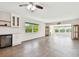 Open living space boasts a built-in bar, wood floors, and views of the pool at 2259 Costa Rican Dr # 23, Clearwater, FL 33763