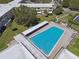 Community swimming pool with clear blue water, lounge chairs, shade and green space for recreation and relaxation at 2259 Costa Rican Dr # 23, Clearwater, FL 33763