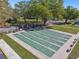 Six shuffleboard courts are surrounded by benches and lush landscaping on a sunny day at 2259 Costa Rican Dr # 23, Clearwater, FL 33763