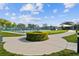 Community tennis courts surrounded by lush greenery and a decorative globe, providing a pleasant recreational space at 2259 Costa Rican Dr # 23, Clearwater, FL 33763