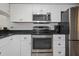 Well-lit kitchen showcasing modern stainless-steel appliances and bright white cabinetry at 2749 Countryside Blvd # 22, Clearwater, FL 33761