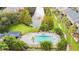 Aerial view of community pool, lake with fountain, and townhome-style condos with balconies and patios at 3005 Bayshore Pointe Dr, Tampa, FL 33611