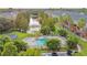 Aerial view of community pool, lake with fountain, and townhome-style condos with balconies and patios at 3005 Bayshore Pointe Dr, Tampa, FL 33611