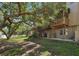 Backyard view of the building with multiple balconies under a large tree, offering ample outdoor living space at 3005 Bayshore Pointe Dr, Tampa, FL 33611