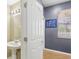 Half bathroom with pedestal sink, faucet and vanity lighting and hardwood floor at 3005 Bayshore Pointe Dr, Tampa, FL 33611