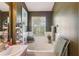 A bright bathroom with a garden tub and a large window with views of the backyard at 3005 Bayshore Pointe Dr, Tampa, FL 33611