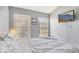 A comfortable bedroom with two windows and a TV mounted on the wall at 3005 Bayshore Pointe Dr, Tampa, FL 33611