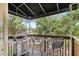 Outdoor deck with a grill and seating, perfect for enjoying outdoor meals surrounded by lush greenery at 3005 Bayshore Pointe Dr, Tampa, FL 33611