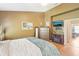 A bright main bedroom with a chest of drawers, fireplace and a TV mounted on the wall at 3005 Bayshore Pointe Dr, Tampa, FL 33611