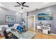 Bright office with gray walls, hardwood floors, seating area and TV on the wall at 3005 Bayshore Pointe Dr, Tampa, FL 33611