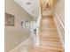 Hardwood staircase bathed in natural light and decorated with artwork at 3005 Bayshore Pointe Dr, Tampa, FL 33611