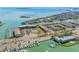 Overhead shot of waterfront condos featuring tennis courts, boat docks, and convenient beach access at 301 Madeira Cir, Tierra Verde, FL 33715