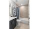Elegant bathroom with white toilet, marble countertops, neutral tile, and decorative turtle art at 301 Madeira Cir, Tierra Verde, FL 33715