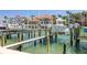 A boat lift supports a motorboat, enabling access to the scenic water and waterfront homes at 301 Madeira Cir, Tierra Verde, FL 33715