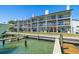Exterior elevation of a waterfront condo showcasing balconies with dock access at 301 Madeira Cir, Tierra Verde, FL 33715