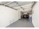 Spacious garage with ample room for parking and storage, featuring a car and shelving at 301 Madeira Cir, Tierra Verde, FL 33715
