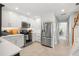 Bright kitchen featuring stainless steel appliances, white cabinets, and ample counter space at 301 Madeira Cir, Tierra Verde, FL 33715