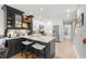 Modern kitchen features sleek black and white cabinetry, stainless steel appliances, and island seating at 301 Madeira Cir, Tierra Verde, FL 33715