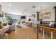 Open-concept living room with fireplace, dining area, and waterfront views, perfect for entertaining at 301 Madeira Cir, Tierra Verde, FL 33715
