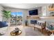 Inviting living room with modern fireplace and sliding glass doors to balcony with canal view at 301 Madeira Cir, Tierra Verde, FL 33715