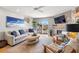 Bright living room featuring stylish furnishings, a fireplace, large sliding glass doors, and a balcony at 301 Madeira Cir, Tierra Verde, FL 33715