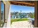 Charming waterfront patio with serene views, a table, and a grill at 301 Madeira Cir, Tierra Verde, FL 33715