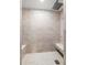 Luxurious walk-in shower with tile surround, bench seating, and rain showerhead at 301 Madeira Cir, Tierra Verde, FL 33715