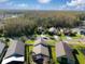 Birds-eye view of houses featuring manicured lawns backing up to peaceful wooded areas at 30829 Iverson Dr, Wesley Chapel, FL 33543