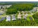 Aerial view of neighborhood with properties surrounded by trees and ponds at 30829 Iverson Dr, Wesley Chapel, FL 33543