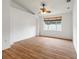 A spacious bedroom with wood floors, fan, and a window providing natural light at 30829 Iverson Dr, Wesley Chapel, FL 33543