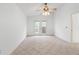 Bedroom with tile floors, neutral walls, ceiling fan, and French door access to backyard at 30829 Iverson Dr, Wesley Chapel, FL 33543