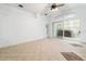 Spacious bonus room with tile flooring, sliding doors, and a ceiling fan at 30829 Iverson Dr, Wesley Chapel, FL 33543