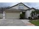 Charming one-story home with attached garage and front landscaping at 30829 Iverson Dr, Wesley Chapel, FL 33543