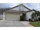 Charming home featuring a two-car garage, a well-maintained lawn, and attractive curb appeal at 30829 Iverson Dr, Wesley Chapel, FL 33543