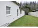 Exterior view showcasing a well-maintained lawn, white siding and a white fence at 30829 Iverson Dr, Wesley Chapel, FL 33543