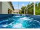 The outdoor jacuzzi tub is crystal clear and ready for use. It has jets and is surrounded by trees at 30829 Iverson Dr, Wesley Chapel, FL 33543