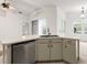 Kitchen island with stainless steel dishwasher and sink offers functional design at 30829 Iverson Dr, Wesley Chapel, FL 33543