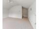 Spacious carpeted loft with vaulted ceilings and a modern ceiling fan at 30829 Iverson Dr, Wesley Chapel, FL 33543