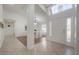 Bright foyer showcasing elegant tile flooring and providing a view of the dining area at 505 Stratfield Dr, Lutz, FL 33549