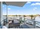 Relaxing balcony area with comfortable seating and a beautiful view of the harbor and palm trees at 5120 Marina Way # Slip Ew 17, Tampa, FL 33611