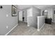 Hallway with wood-look floors, gray walls, white trim, and doorways leading to other rooms in the house at 5807 Cay Cove Ct, Tampa, FL 33615